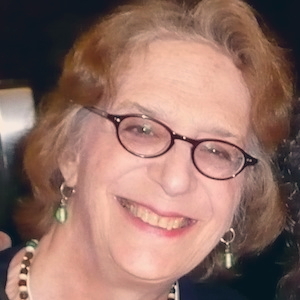 A photo of author Rachel Pollack. She is wearing glasses and smiling.